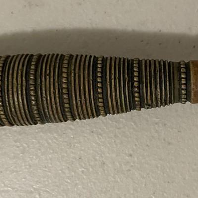 Sale Photo Thumbnail #218: The blade shows signs of age and possible wear. There are  metal bands wrapped around the handle with spaced dots which adds both texture and reinforcement, suggesting it was made with function in mind. Please see photos for more details.