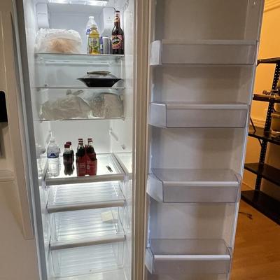 Sale Photo Thumbnail #232: The refrigerator features an indoor ice and water dispenser. The refrigerator has adjustible shelves, in door can caddies, and deli drawers and does work. Please see photos for more details.