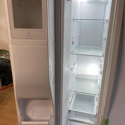 Sale Photo Thumbnail #234: The refrigerator features an indoor ice and water dispenser. The refrigerator has adjustible shelves, in door can caddies, and deli drawers and does work. Please see photos for more details.