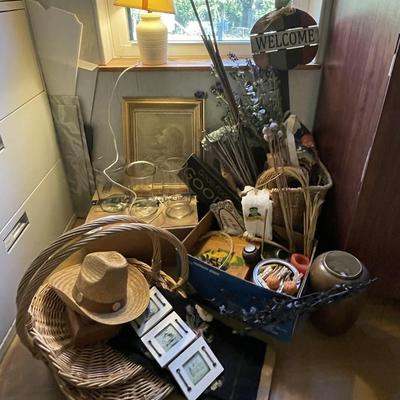 Sale Photo Thumbnail #298: . Box of clear glass vases, dry flowers, framed artwork, small table lamp, needlepoint tapestry, baskets and much more. Please see photos for more details.