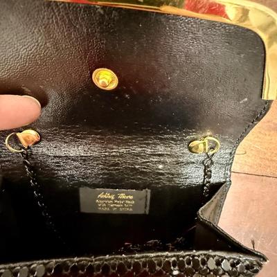 Sale Photo Thumbnail #290: Black sequins with gold tone snap closure. Chain shoulder strap tucks inside. Near new condition.