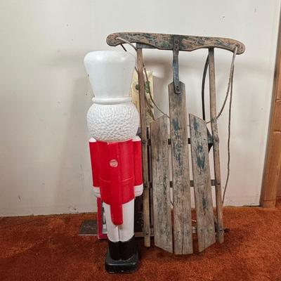 LOT 94: Vintage Wooden Childs Sled, Nutcracker Blow Mold (no light), Cast Iron Tree Stand and Lemax Village Train System