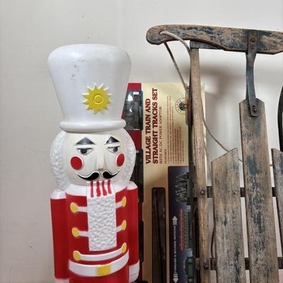 LOT 94: Vintage Wooden Childs Sled, Nutcracker Blow Mold (no light), Cast Iron Tree Stand and Lemax Village Train System
