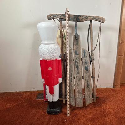 LOT 94: Vintage Wooden Childs Sled, Nutcracker Blow Mold (no light), Cast Iron Tree Stand and Lemax Village Train System