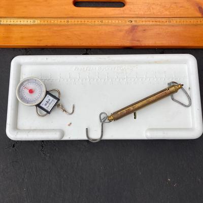 LOT 119: Fishing Nets, Fishing Pole Holders, Fish Filleting Boards, and Scales