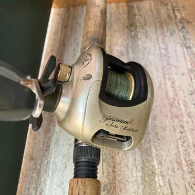 LOT 120: Wooden Fishing Rod Holder with Rods and Reels