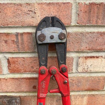 LOT 123: Collection of Tools Including a Plumber Wrench, Bolt Cutter Clamps, Saw, Extension Cord and Spool