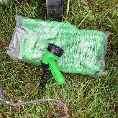 LOT 133: Gardening Tools Including Rakes, Seed Spreader, Ax, Hose and More