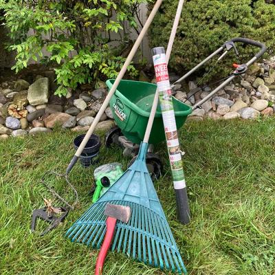LOT 133: Gardening Tools Including Rakes, Seed Spreader, Ax, Hose and More