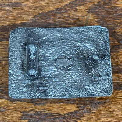 LOT 142: Outdoor Life Collection: Made in USA Belt Buckle, Danbury Mint Collectors Plate, Binoculars, Fishing Reel & Resin Striped Bass