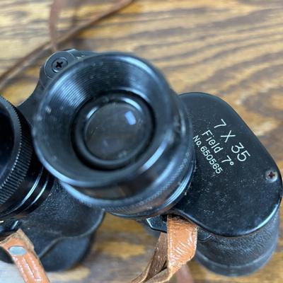 LOT 142: Outdoor Life Collection: Made in USA Belt Buckle, Danbury Mint Collectors Plate, Binoculars, Fishing Reel & Resin Striped Bass