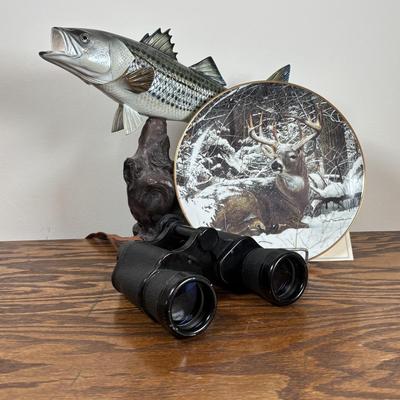 LOT 142: Outdoor Life Collection: Made in USA Belt Buckle, Danbury Mint Collectors Plate, Binoculars, Fishing Reel & Resin Striped Bass