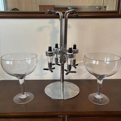 LOT 145: Revolving Liquor Caddy, Hand Crafted Cheese & Cracker Jug, Oversize Stell Artois & Champagne Glasses