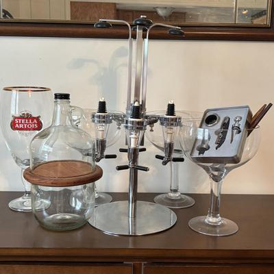 LOT 145: Revolving Liquor Caddy, Hand Crafted Cheese & Cracker Jug, Oversize Stell Artois & Champagne Glasses