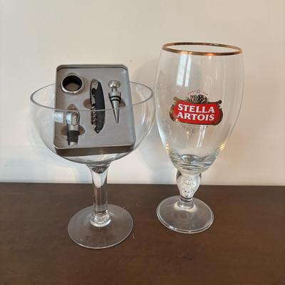 LOT 145: Revolving Liquor Caddy, Hand Crafted Cheese & Cracker Jug, Oversize Stell Artois & Champagne Glasses