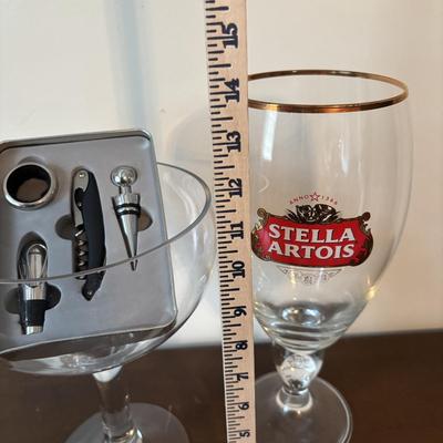 LOT 145: Revolving Liquor Caddy, Hand Crafted Cheese & Cracker Jug, Oversize Stell Artois & Champagne Glasses