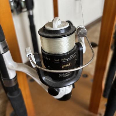 LOT 146: Fishing Rod Holder w/Fishing Rods & Reels