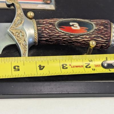 Sale Photo Thumbnail #1173: The product is a NASCAR Dale Earnhardt #3 The Intimidator Bowie Knife with Plaque, paying tribute to the legendary auto racing driver. Featuring a plaque with the image and name of Dale Earnhardt, this unique item is perfect for fans of NASCAR and auto ra