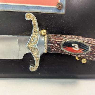 Sale Photo Thumbnail #1170: The product is a NASCAR Dale Earnhardt #3 The Intimidator Bowie Knife with Plaque, paying tribute to the legendary auto racing driver. Featuring a plaque with the image and name of Dale Earnhardt, this unique item is perfect for fans of NASCAR and auto ra
