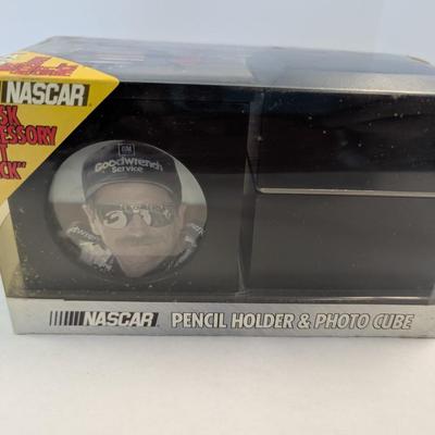 Sale Photo Thumbnail #1201: The Dale Earnhardt NASCAR Desk Accessory Gift Set includes a pencil holder and photo cube featuring the legendary auto racing driver. Fans of NASCAR and auto racing enthusiasts will appreciate this unique and stylish desk accessory set. The collection pay