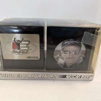 Sale Photo Thumbnail #1200: The Dale Earnhardt NASCAR Desk Accessory Gift Set includes a pencil holder and photo cube featuring the legendary auto racing driver. Fans of NASCAR and auto racing enthusiasts will appreciate this unique and stylish desk accessory set. The collection pay