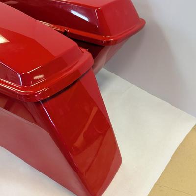 Sale Photo Thumbnail #1557: The Harley Red Ultra Road Street Glide Roadking Hard Saddlebags are high-quality motorcycle accessories designed for maximum storage and protection. These saddlebags are durable and provide ample space for storing belongings while riding the road. The red