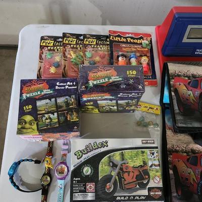 Sale Photo Thumbnail #166: Cars the movie book tote bag lot
Receive everything pictured
Includes two Shrek puzzles, vintage cartoon watches and other toys