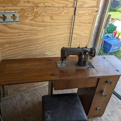 Singer sewing machine in cabinet