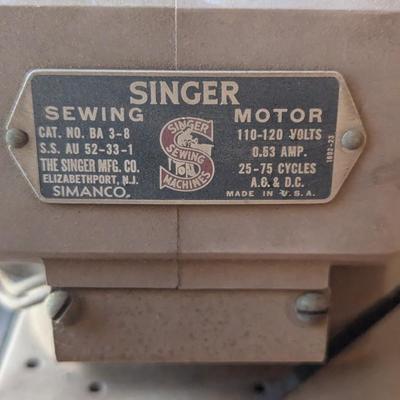 Singer sewing machine in cabinet