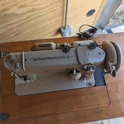 Singer sewing machine in cabinet