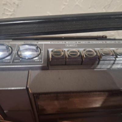 Sale Photo Thumbnail #1083: plugged in and tested radio, sounds great.  No cassettes available to test that part.  Antenna is good. It needs a good cleaning. And the handle is secure on it but doesn't stay in the up position on both sidessee photos.