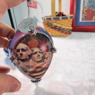 Sale Photo Thumbnail #339: 1 framed picture 15-1/2" x 13-1/2", pin cushon, metal flag, book on the constitution, picture in clear frame, 1 pamphlet on the constitution, 1 flag picture frame, 4 ornaments (liquid filled), basket