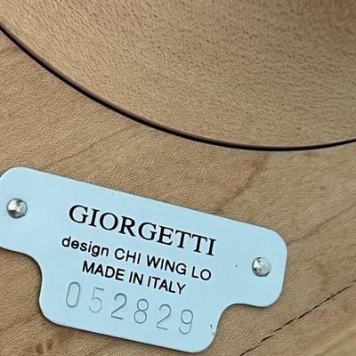 Sale Photo Thumbnail #8: Light Maple colored table with a black glass top.  Table has a round base with brushed metal band on the riser.  The serial number for this table is 052829.  The table was made in Italy. Please note the scratches in the black glass top.  Top is 17 3/4" sq