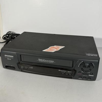 LOT 115D: Syvania VCR Model 2965LF w/ Collection of DVDs