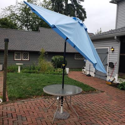 LOT 139: Glass Outdoor Table with Adjustable Umbrella & Stand