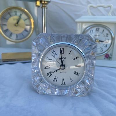 Sale Photo Thumbnail #96: 3 antique battery operated table clocks, selling as a set. Front clock is carved glass, approximately 3"x2"x3". Back left clock is set in glass with gold and silver accents, has "Mom & Dad" etched into gold plate beneath face, and is approximately 6"x1"x6