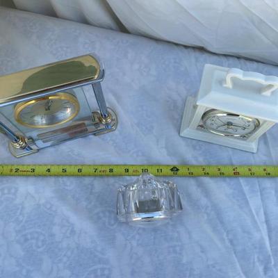 Sale Photo Thumbnail #102: 3 antique battery operated table clocks, selling as a set. Front clock is carved glass, approximately 3"x2"x3". Back left clock is set in glass with gold and silver accents, has "Mom & Dad" etched into gold plate beneath face, and is approximately 6"x1"x6