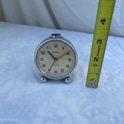 Sale Photo Thumbnail #109: Vintage Soviet Travel Alarm Clock, 11 Jewels brand. Approximately 2.5"x1"x2.5". Wind up details on back. In good condition, a very cool piece of history!