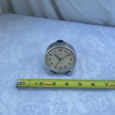 Sale Photo Thumbnail #108: Vintage Soviet Travel Alarm Clock, 11 Jewels brand. Approximately 2.5"x1"x2.5". Wind up details on back. In good condition, a very cool piece of history!