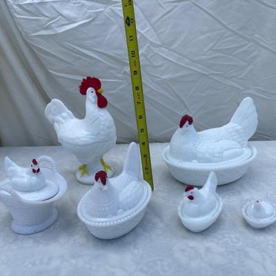 Sale Photo Thumbnail #121: Westmoreland Milk Glass Hen on Nest covered dishes, selling as a set of 6. Includes a rooster and 5 hens of various sizes. Good condition, a few scratches and chips here and there. Very cool set with "WC" (Westmoreland Co) logo inside each lid.