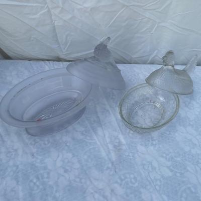 Sale Photo Thumbnail #129: Vintage glass dishes with bird lids, selling as set of 2. Could use a good scrub, but otherwise in great condition. Left dish is approximately 6"x4"x7" including foot and bird ornament with lightly frosted glass. Right dish is approximately 6"x4"x5".