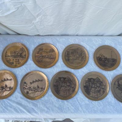 Sale Photo Thumbnail #130: 9 vintage Wendell August Forge Limited Edition Christmas Plates, years 1981-1988. Duplicates of 1985 and 1986, missing 1987. Various Christmas designs on solid brass plates with dimpled texture. In good condition and each plate has a small hook on the bac