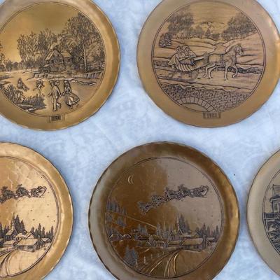 Sale Photo Thumbnail #132: 9 vintage Wendell August Forge Limited Edition Christmas Plates, years 1981-1988. Duplicates of 1985 and 1986, missing 1987. Various Christmas designs on solid brass plates with dimpled texture. In good condition and each plate has a small hook on the bac