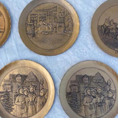 Sale Photo Thumbnail #134: 9 vintage Wendell August Forge Limited Edition Christmas Plates, years 1981-1988. Duplicates of 1985 and 1986, missing 1987. Various Christmas designs on solid brass plates with dimpled texture. In good condition and each plate has a small hook on the bac