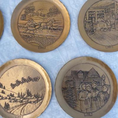Sale Photo Thumbnail #133: 9 vintage Wendell August Forge Limited Edition Christmas Plates, years 1981-1988. Duplicates of 1985 and 1986, missing 1987. Various Christmas designs on solid brass plates with dimpled texture. In good condition and each plate has a small hook on the bac