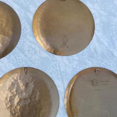 Sale Photo Thumbnail #141: 9 vintage Wendell August Forge Limited Edition Christmas Plates, years 1981-1988. Duplicates of 1985 and 1986, missing 1987. Various Christmas designs on solid brass plates with dimpled texture. In good condition and each plate has a small hook on the bac