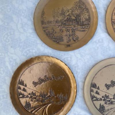 Sale Photo Thumbnail #131: 9 vintage Wendell August Forge Limited Edition Christmas Plates, years 1981-1988. Duplicates of 1985 and 1986, missing 1987. Various Christmas designs on solid brass plates with dimpled texture. In good condition and each plate has a small hook on the bac
