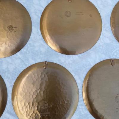 Sale Photo Thumbnail #138: 9 vintage Wendell August Forge Limited Edition Christmas Plates, years 1981-1988. Duplicates of 1985 and 1986, missing 1987. Various Christmas designs on solid brass plates with dimpled texture. In good condition and each plate has a small hook on the bac