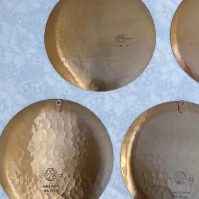 Sale Photo Thumbnail #137: 9 vintage Wendell August Forge Limited Edition Christmas Plates, years 1981-1988. Duplicates of 1985 and 1986, missing 1987. Various Christmas designs on solid brass plates with dimpled texture. In good condition and each plate has a small hook on the bac
