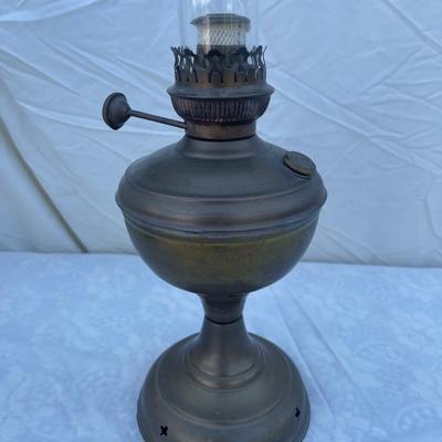 Sale Photo Thumbnail #164: Antique Brass Oil Lamp with super skinny glass chimney. Chimney could seat better on the lamp, but otherwise the lamp is in good condition! Base is about 5" across, total height is about 21" including glass chimney.